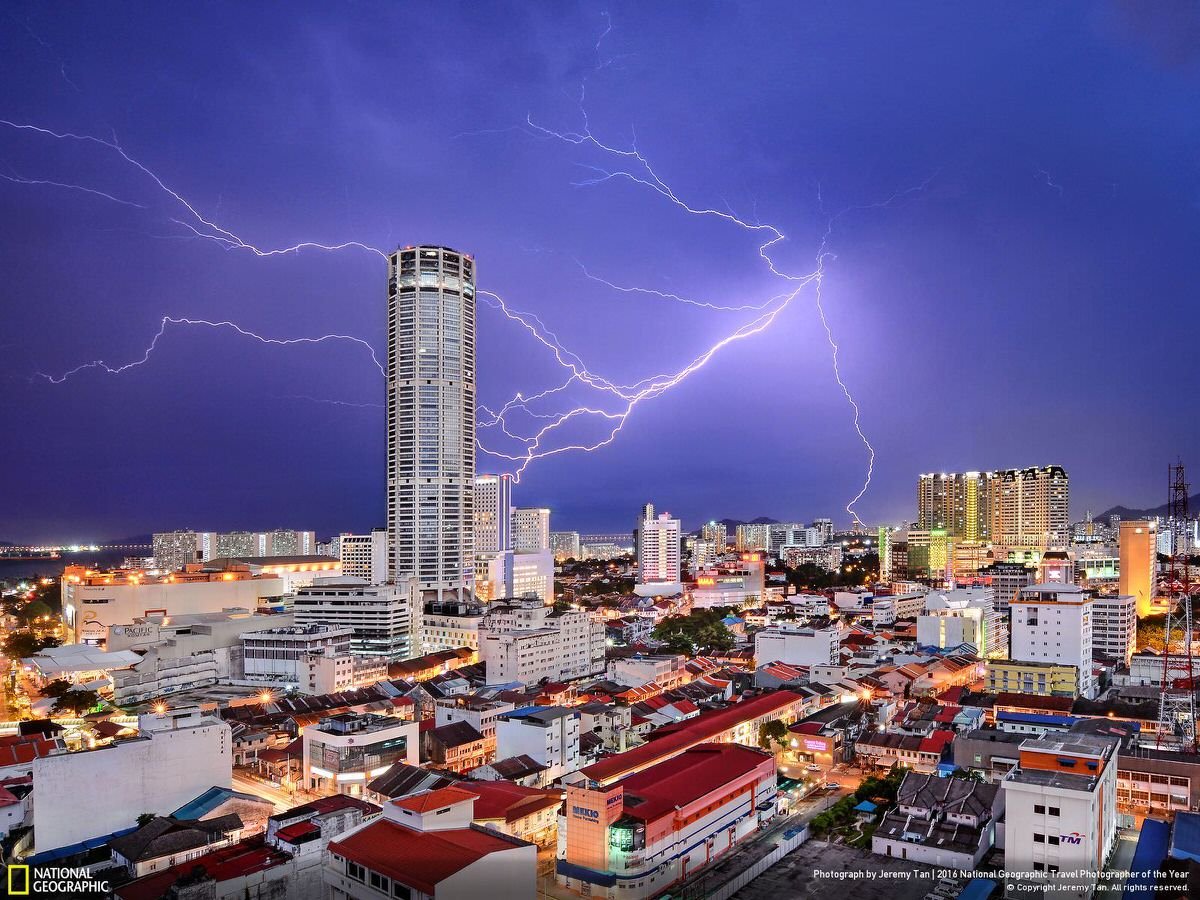 Lightning seemingly strikes Komtar Tower, the most iconic landmark of George Town, capital of Penang state in Malaysia, during a thunderstorm. It is symbolic of the rejuvenation that the city, famous for a unique blend of centuries-old buildings and modern structures, has enjoyed in recent years. While many of its old neighborhoods fell into neglect in the 1990s and early 2000s, a UNESCO World Heritage listing in 2008 sparked a transformation. | CATEGORY: Cities